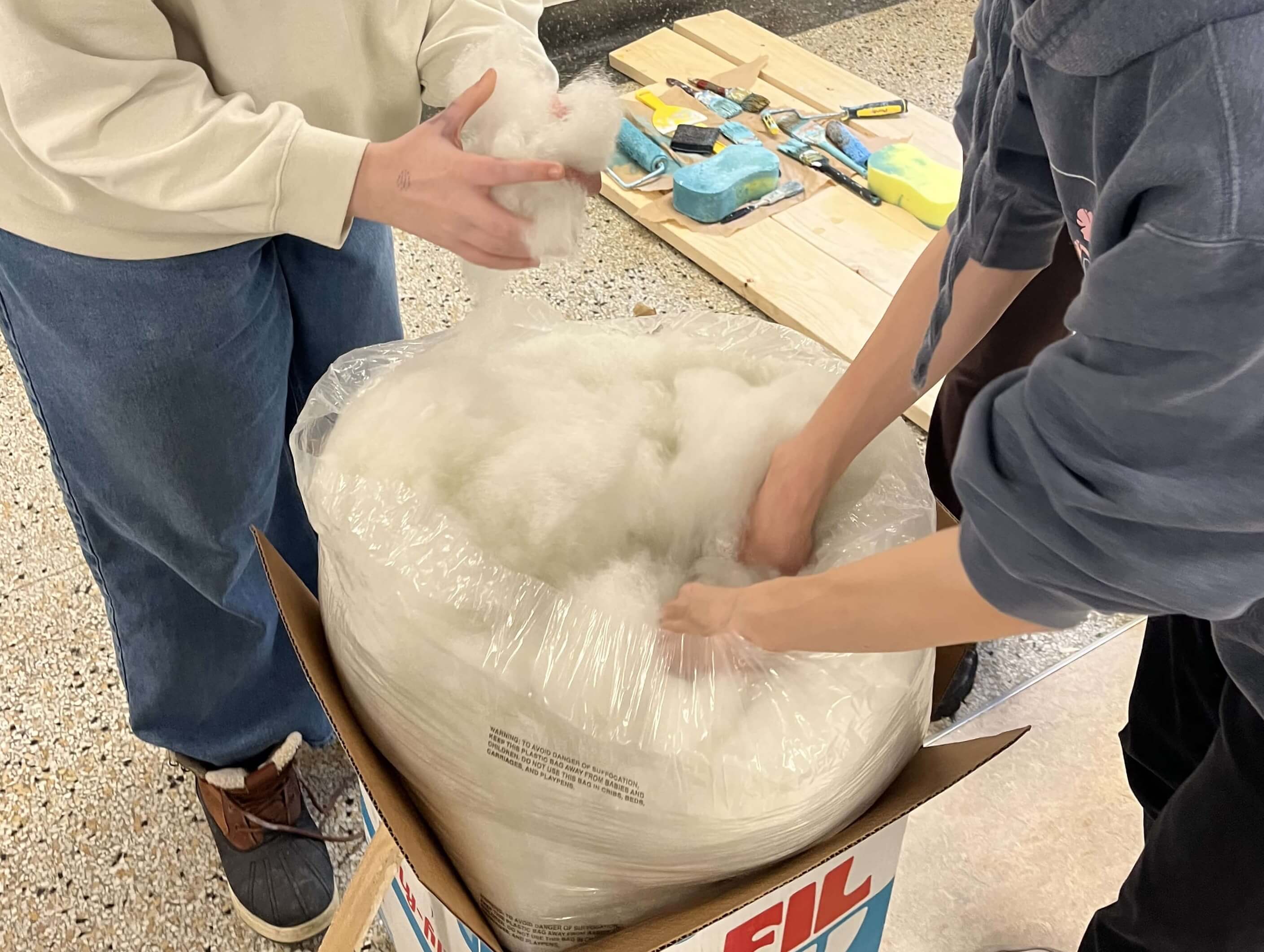 Two team members holding stuffing.